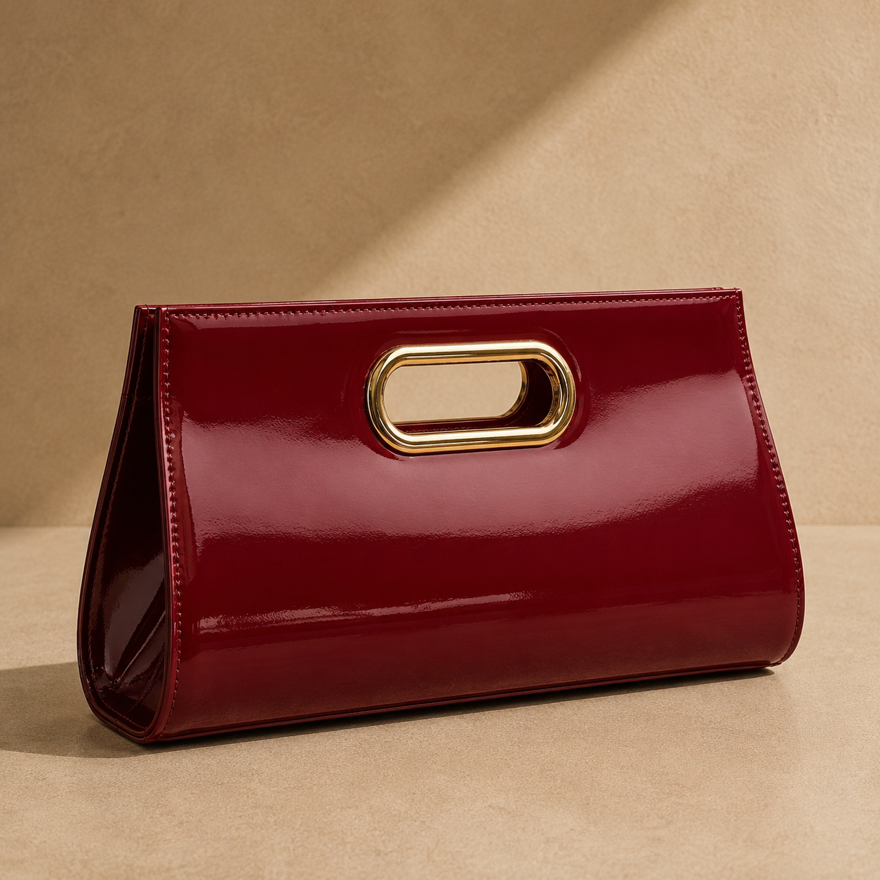 Red clutch bag with a gold handle on a beige background
