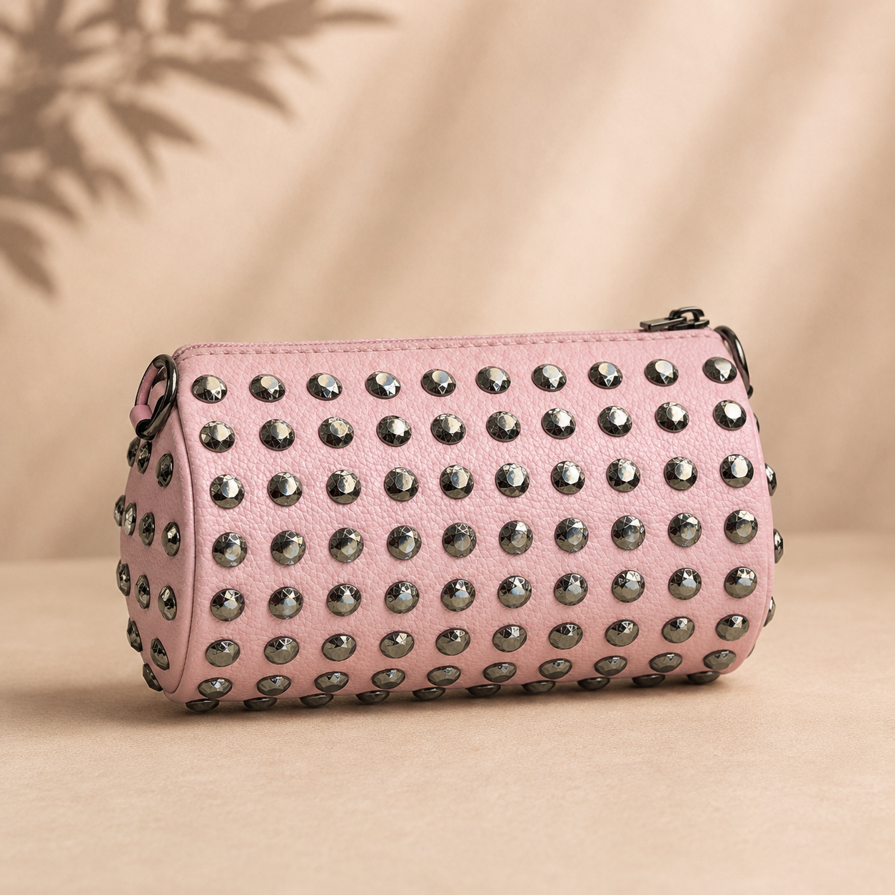 Pink studded bag on a beige background