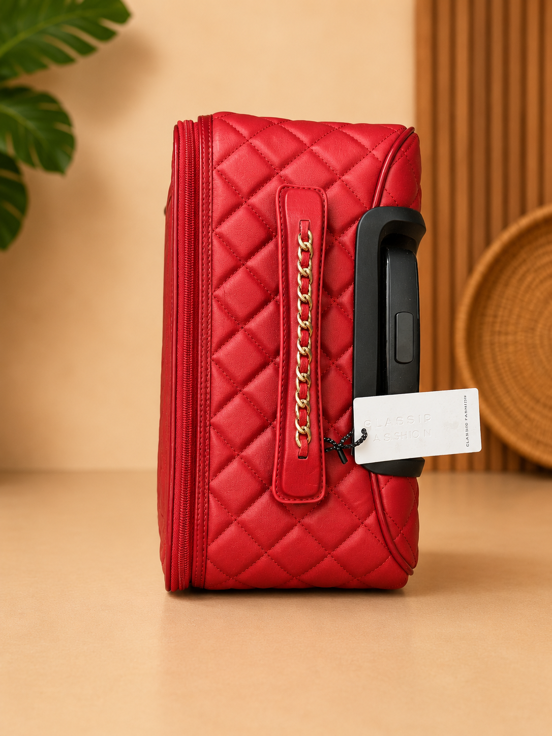 Red quilted handbag with gold chain detail on a beige surface