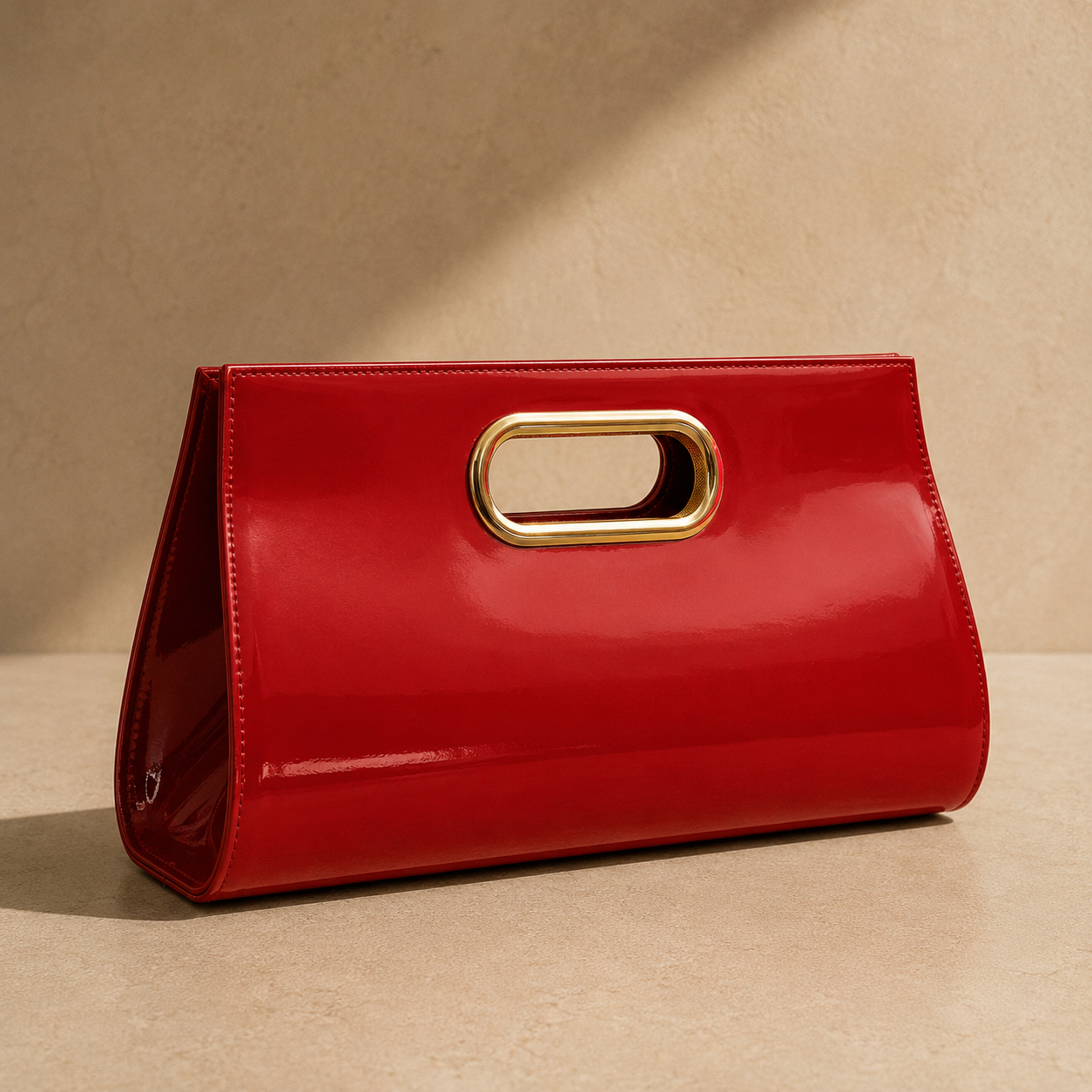 Red clutch with a gold handle on a beige background