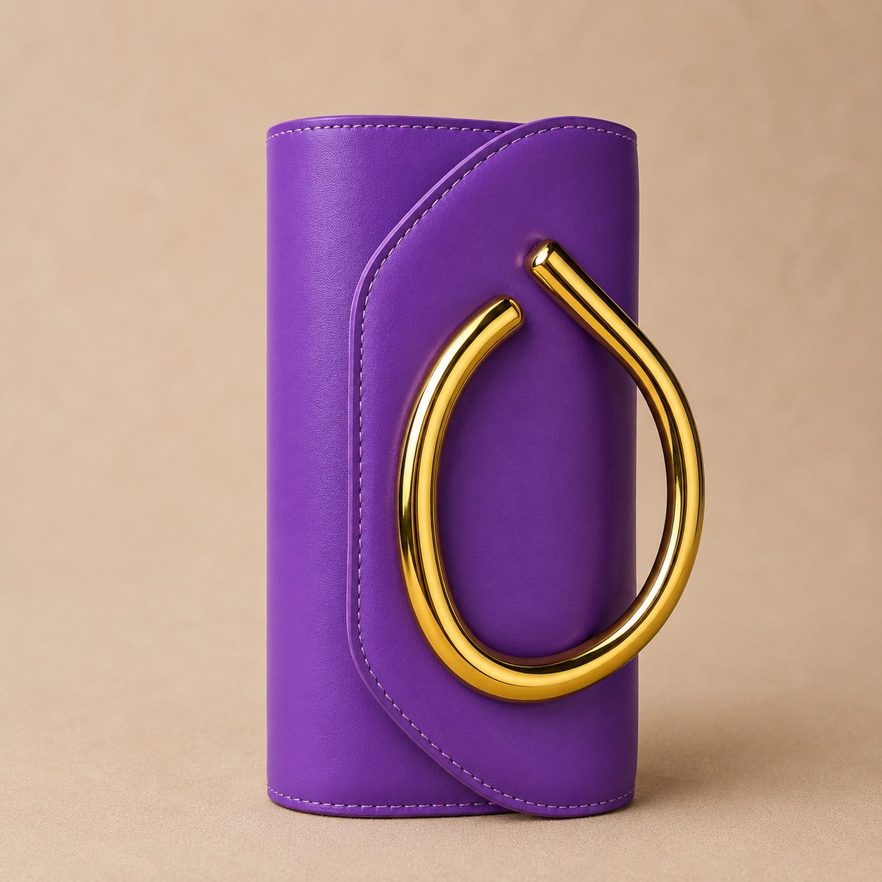Purple clutch with a gold ring handle on a beige background