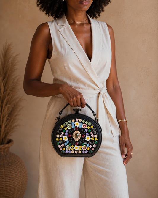 Woman holding a floral handbag against a beige background