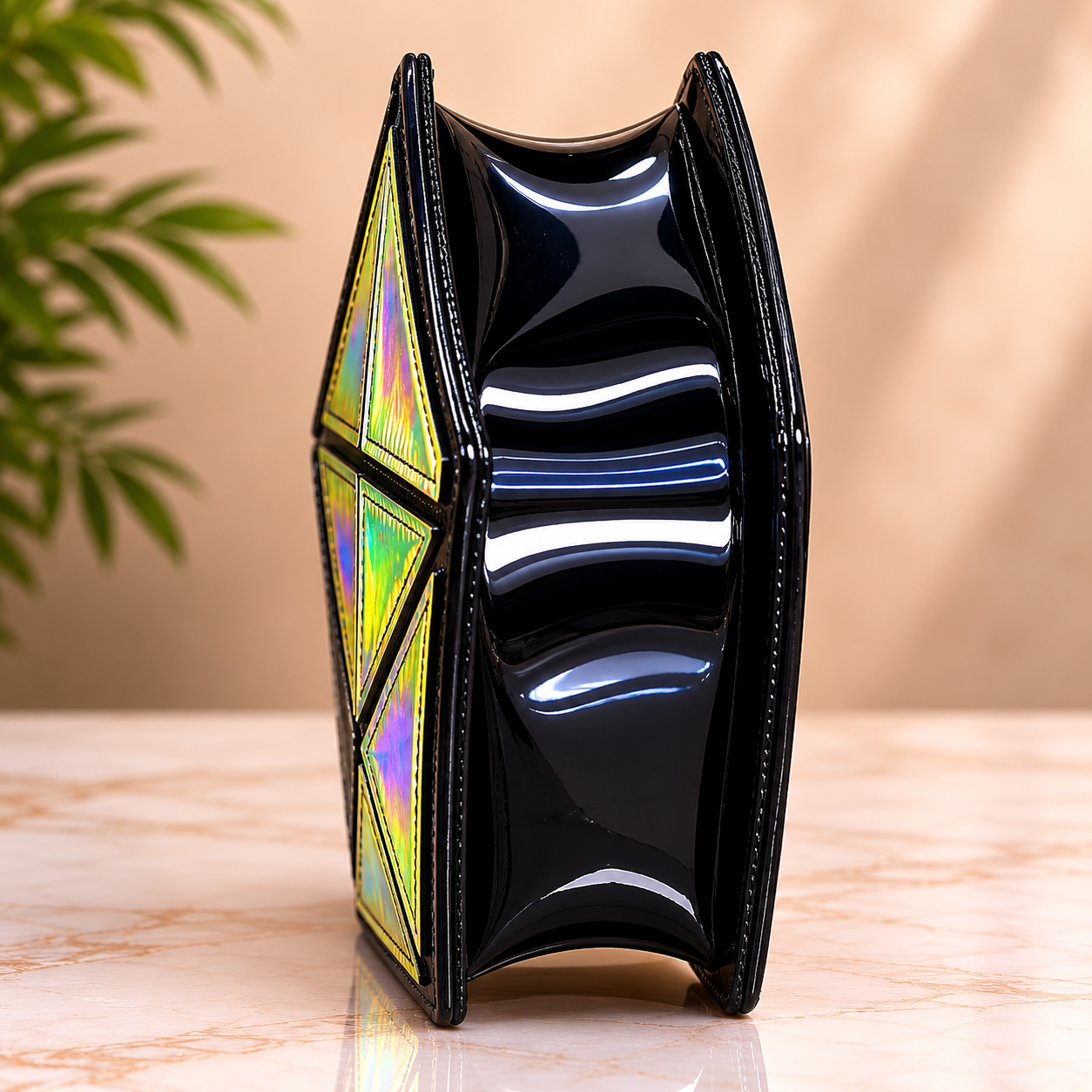 Black geometric clutch with colorful interior on a wooden surface