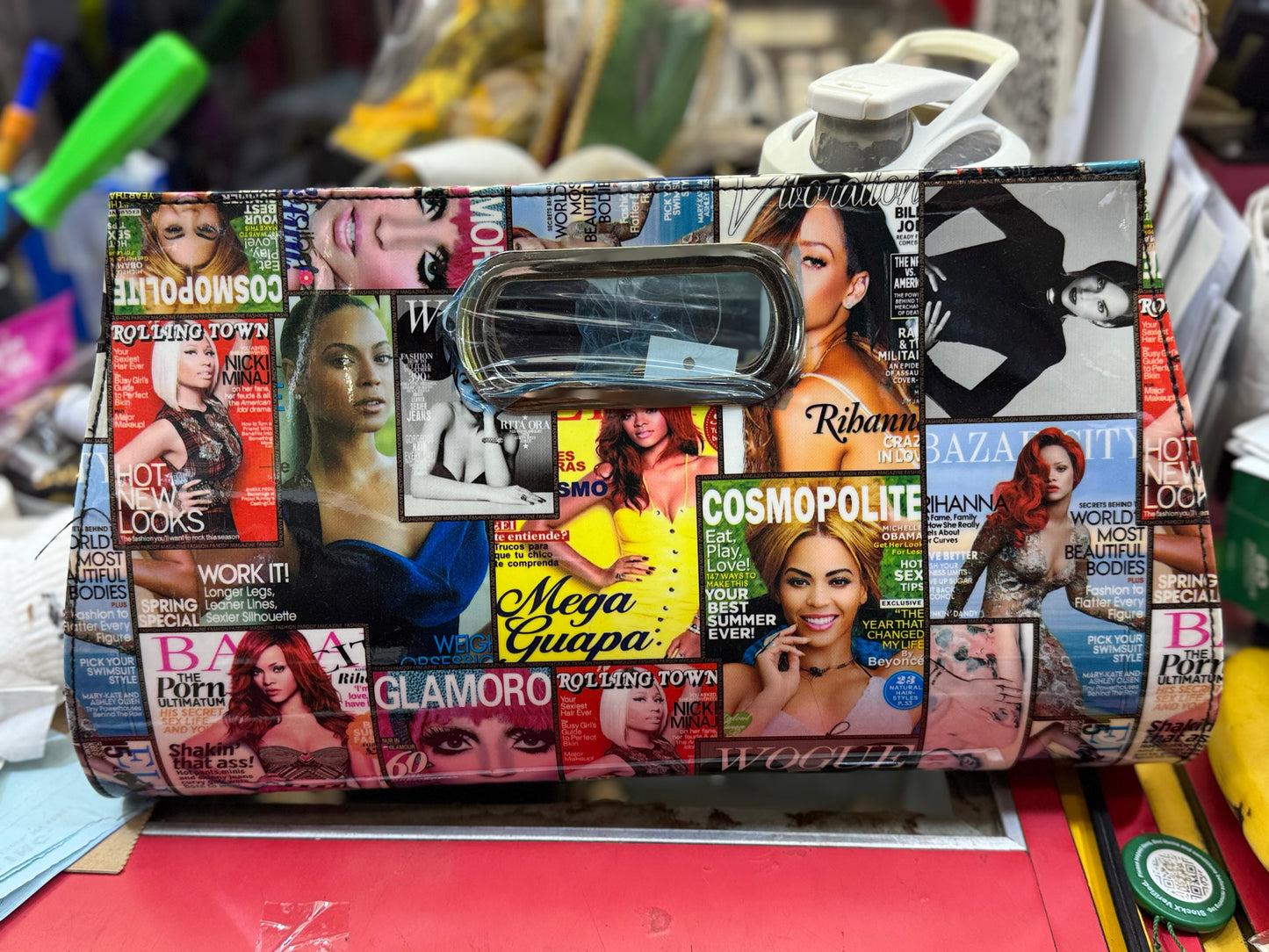 Clutch with magazine cover pattern on a cluttered background